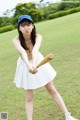 A woman in a white skirt holding a baseball bat.